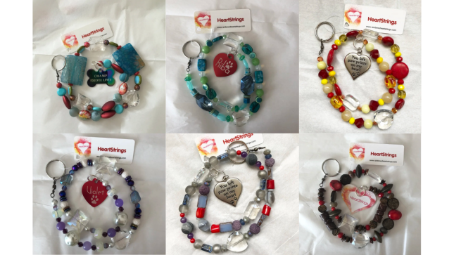 Six colorful handmade HeartStrings featuring beads, crystals, key rings, and pet remembrance charms by Carolyn Beavers and Colleen Marquez.