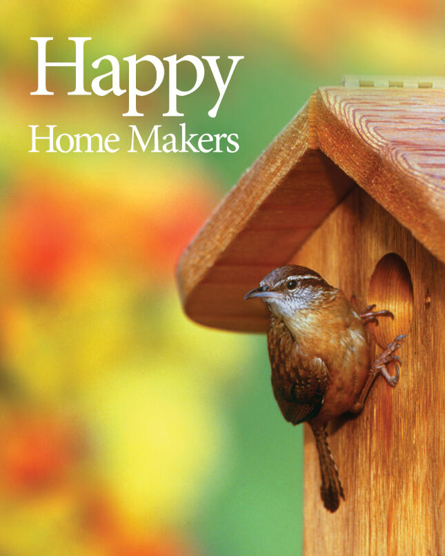 A wren perched at the entrance of a wooden bird house against a softly blurred spring background, with the words &ldquo;Happy Home Makers.&rdquo;