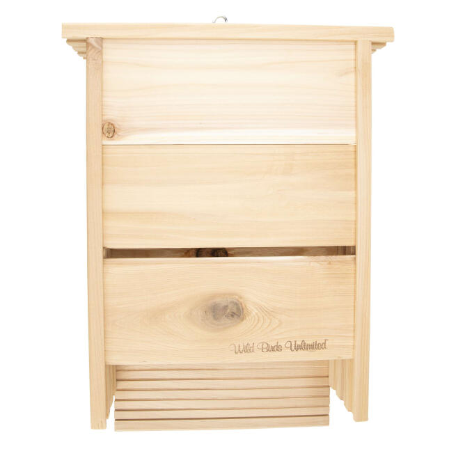 Natural wood Wild Birds Unlimited bat house with narrow chambers and a grooved landing area.
