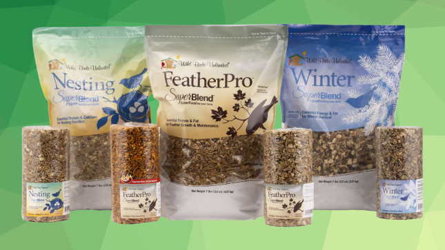 Bags and cylinders of Wild Birds Unlimited Nesting, FeatherPro, and Winter SuperBlend seasonal bird foods displayed against a green background.